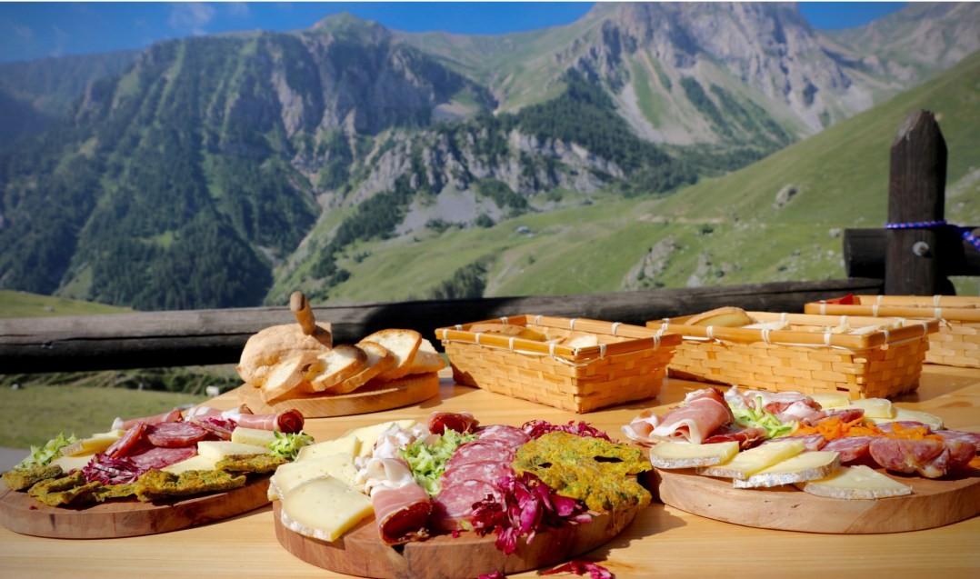 Piedmontese cured meats and cheeses served on a terrace in the Alps